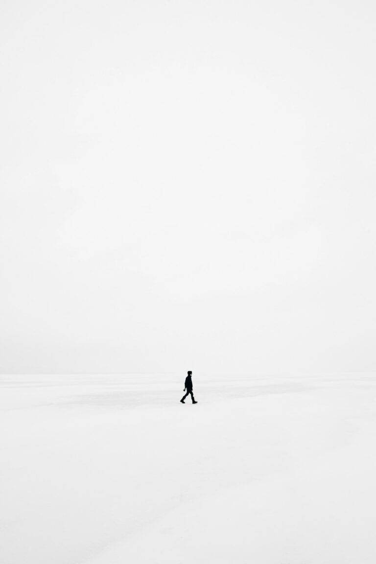 man in distance in white room